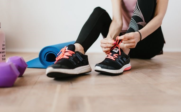 woman sitting on luxury vinyl home gym flooring